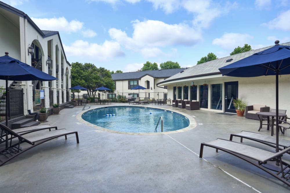 Swimming pool and lovely pool deck with modern furniture at The Fountains of Preston Hollow in Dallas, Texas