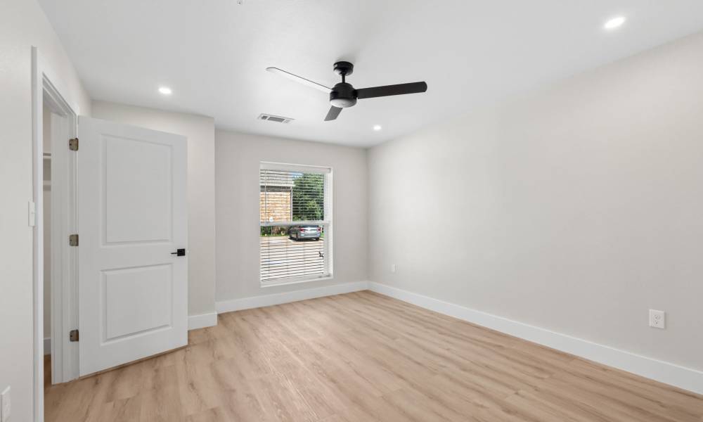 Bedroom with a ceiling fan at Lake Meadows in Garland, Texas