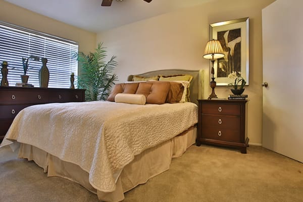 Spacious bedroom with a ceiling fan at Willow Oaks Apartments in Bryan, Texas