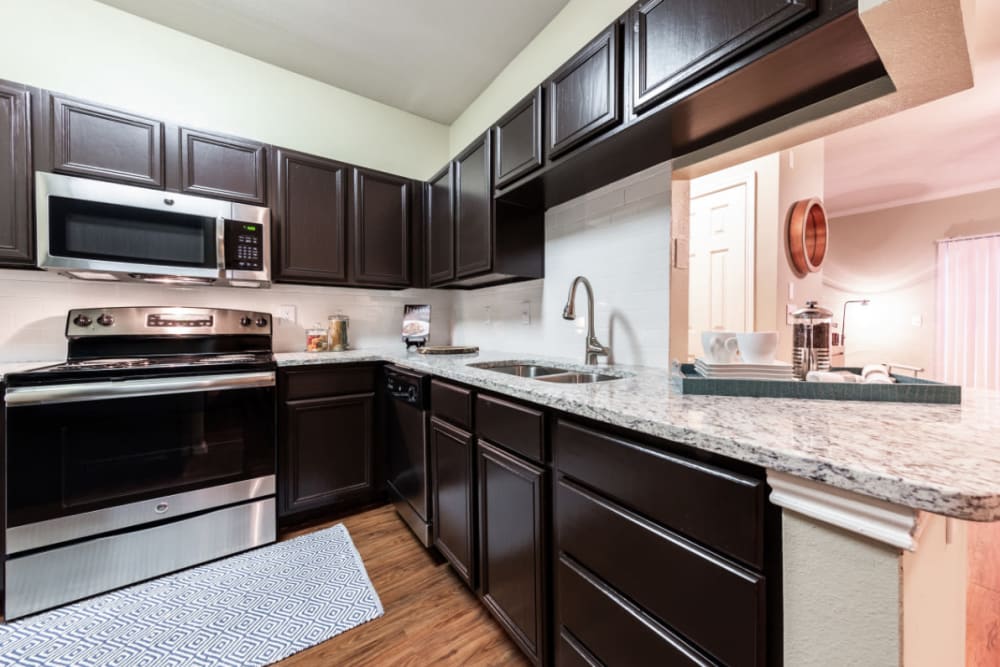 Kitchen with granite counters at Marquis at Ladera Vista in Austin, Texas