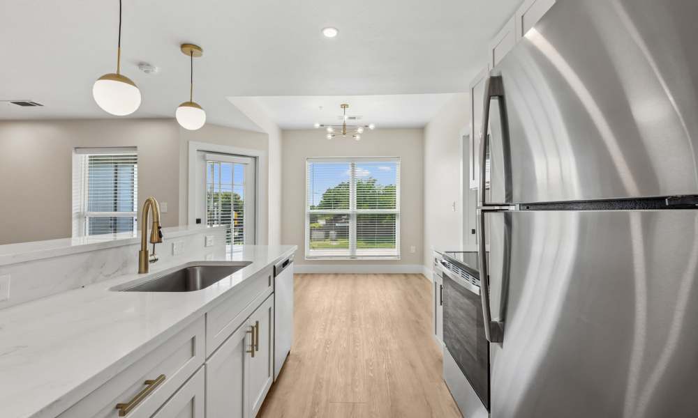 Kitchen with wooden cabinets at Lake Meadows in Garland, Texas