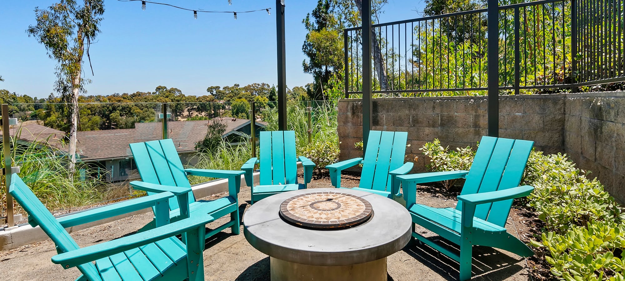 Blue chairs around a firepit at The Avenue at Carlsbad, Carlsbad, California