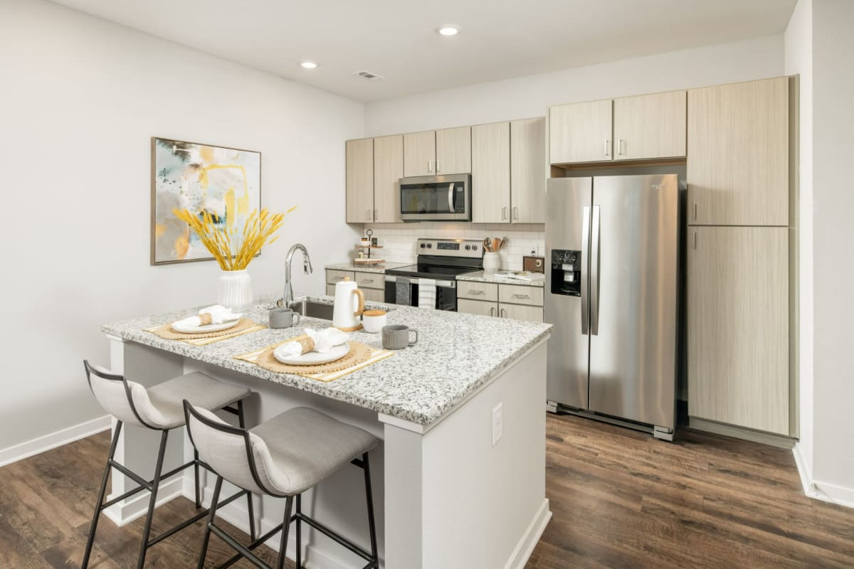 Kitchen with stainless-steel appliances and granite countertops at The Wyatt, Gilbert, Arizona