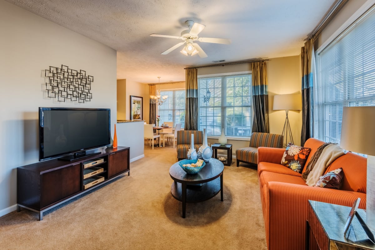 Living room and dining area of a beautiful model apartment at The Preserve at Grande Oaks in Fayetteville, North Carolina