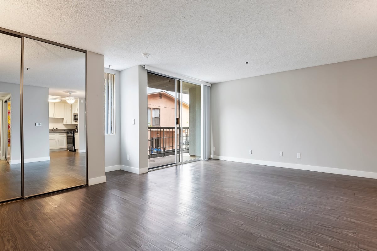 Bedroom with mirrored closet doors at Media Towers, Los Angeles, California