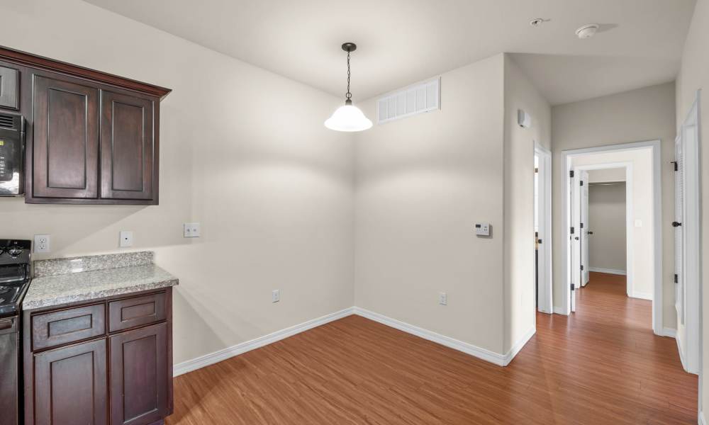Hallway with wood-style flooring at Las Torres Apartments in El Paso, Texas