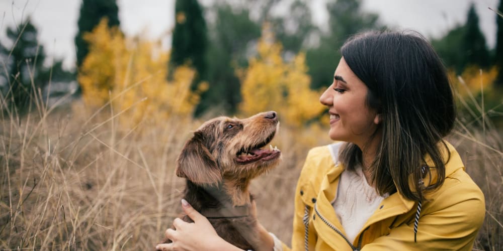 Resident hugging her dog at Quail Hill Apartments in Castro Valley, California