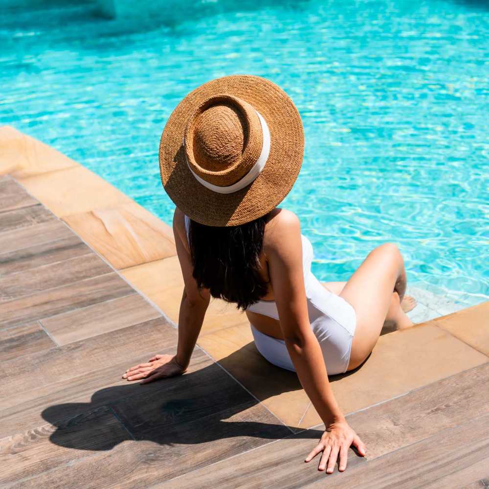 Residen sitting on the edge of the pool at Spanish Oaks in Charleston, South Carolina