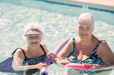 Residents enjoying time in the beautiful pool at Las Palomas Senior Living in Mesa, Arizona