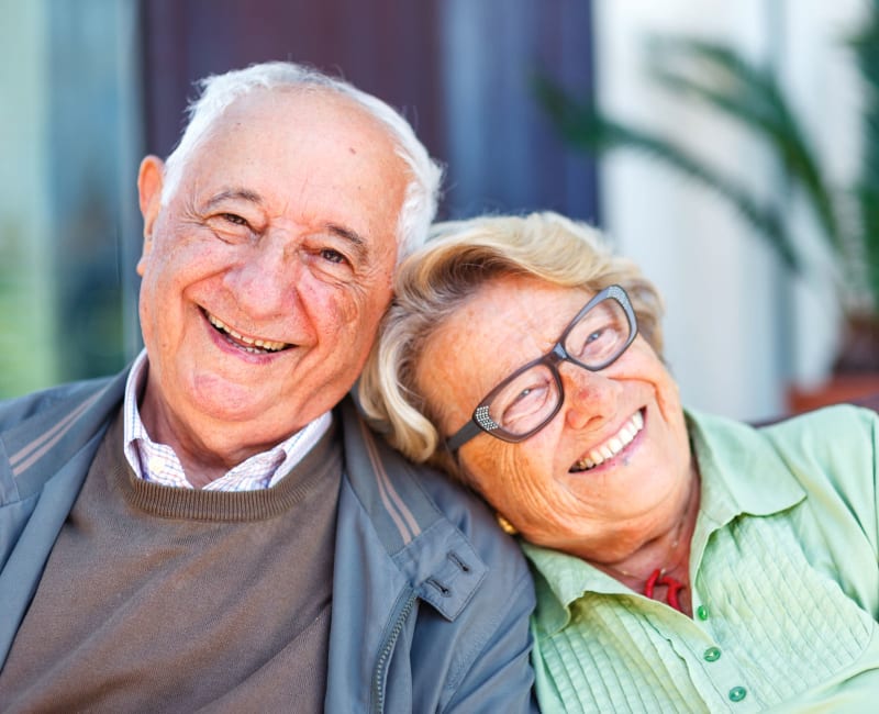 Senior Couple Sitting outside at Arbor Glen Senior Living in Lake Elmo, Minnesota