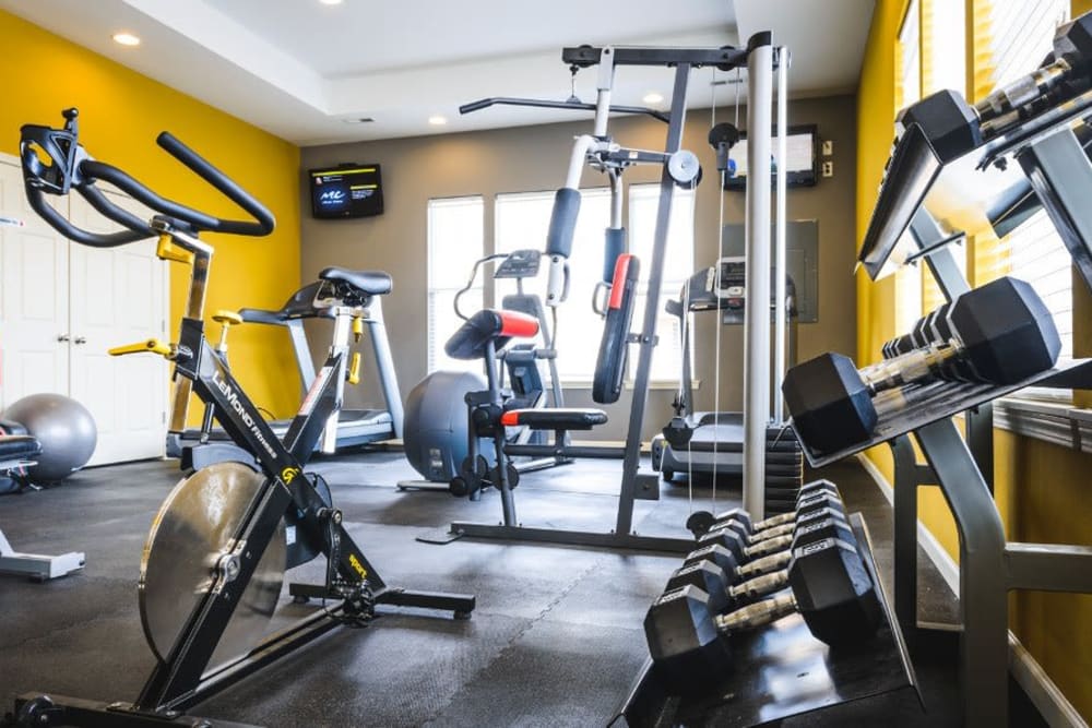 Resident gym with individual workout stations at Alvadora Apartments in Lawrence, Kansas
