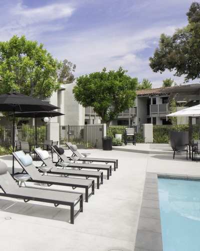 Pool patio with lounge chairs at Breve Park Apartment Homes, Anaheim, California