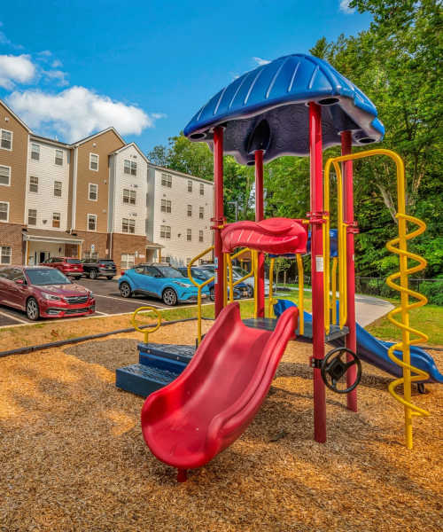 Playground with apartments in the background at Magnolia Greene in Lavale, Maryland