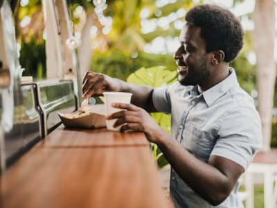 Resident showing a meal at a restaurant near at Anatole at the Pines in Conroe, Texas