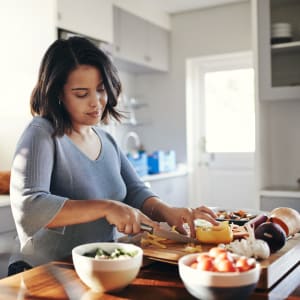 Resident making lunch in their new kitchen at Bent Creek Apartments in Lewisville, Texas