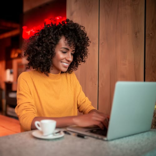 A woman gets some work done on her laptop near Elan 41 Apartments in Seattle, Washington