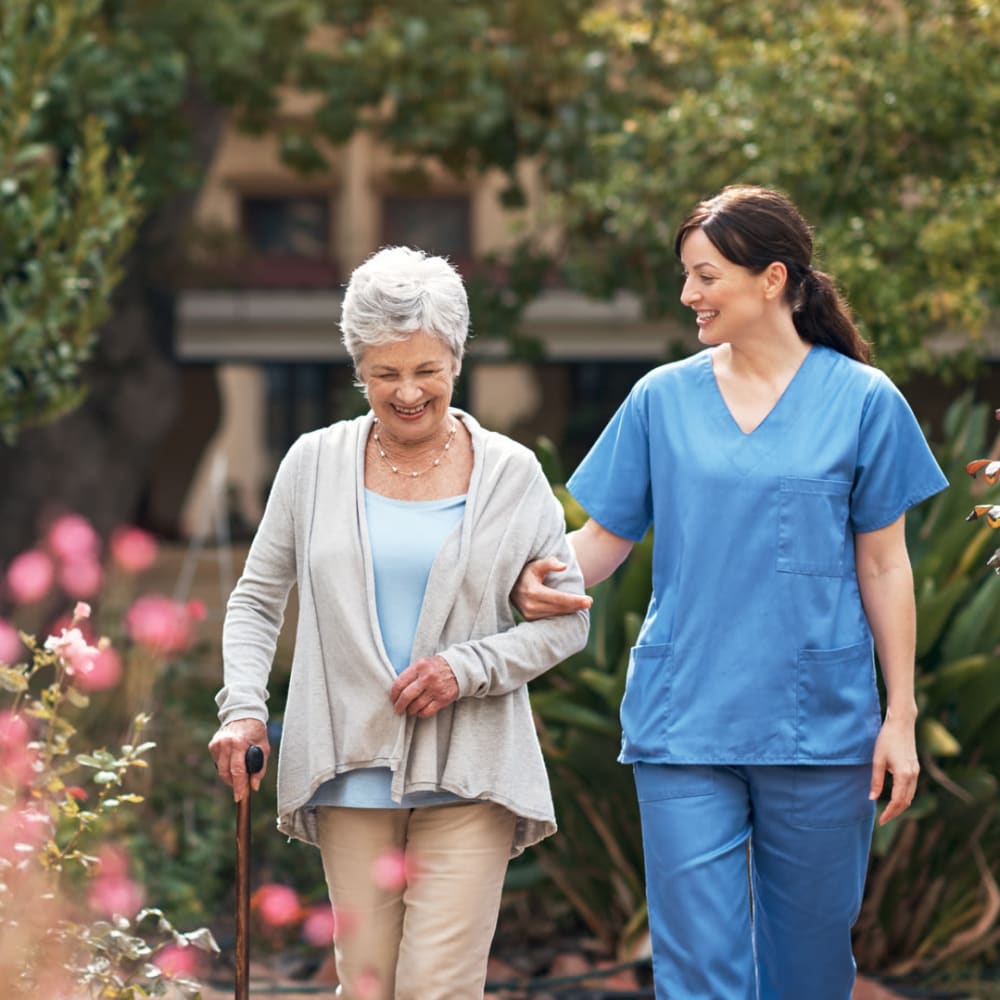 A caretaker going for a walk with a resident at English Meadows Laurens Campus in Laurens, South Carolina