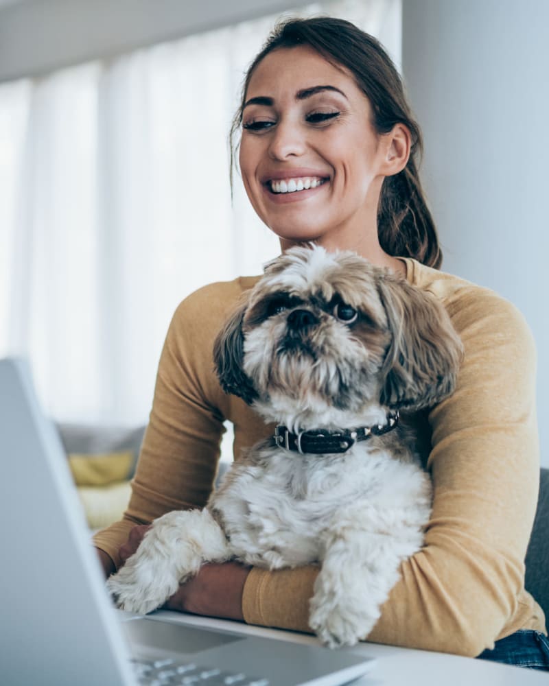 Resident with a dog on her lap at Oakshade Commons in Davis, California