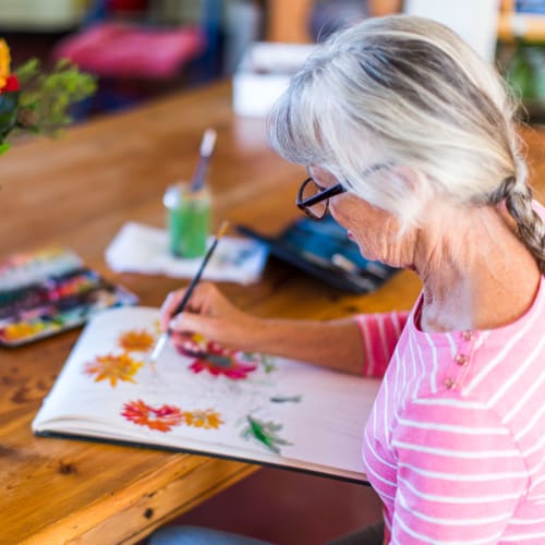 Resident painting inline at Oxford Springs Tulsa Memory Care in Tulsa, Oklahoma