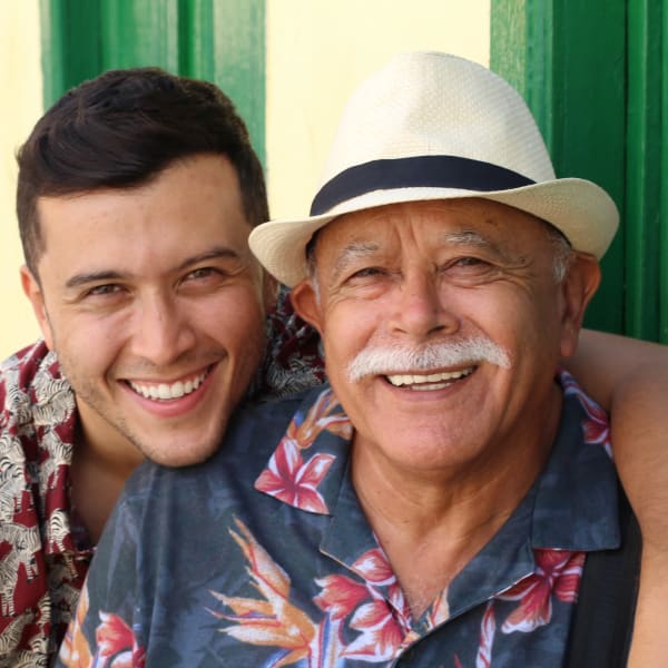 Resident and his son smiling for a photo at Pacifica Senior Living Heritage Hills in Hendersonville, North Carolina