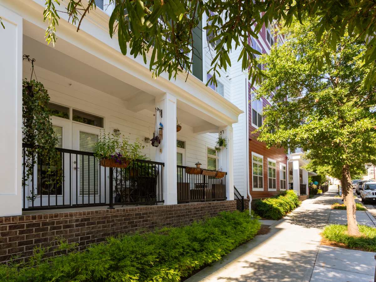 Gated white porch with black railing and greenery at Ardmore & Twenty Eighth in Atlanta, Georgia