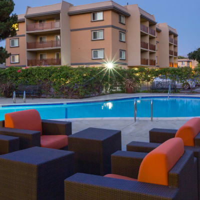 Lounge area near one of the swimming pools at dusk at Waterstone Fremont in Fremont, California