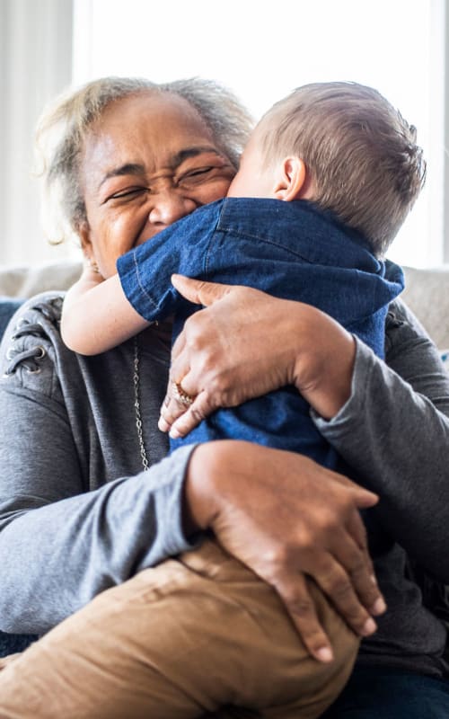 Resident holding a young family member at Regency Woodland in Salem, Oregon