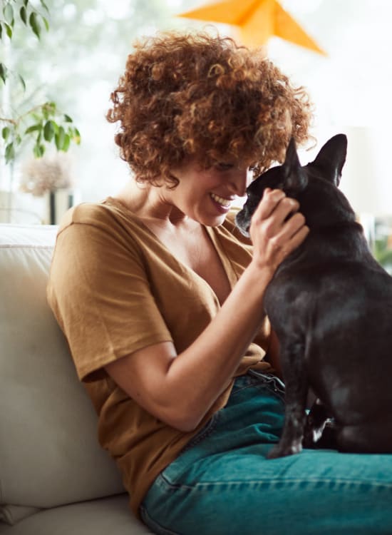 Resident relaxing with her small dog at Solaire 1150 Ripley in Silver Spring, Maryland