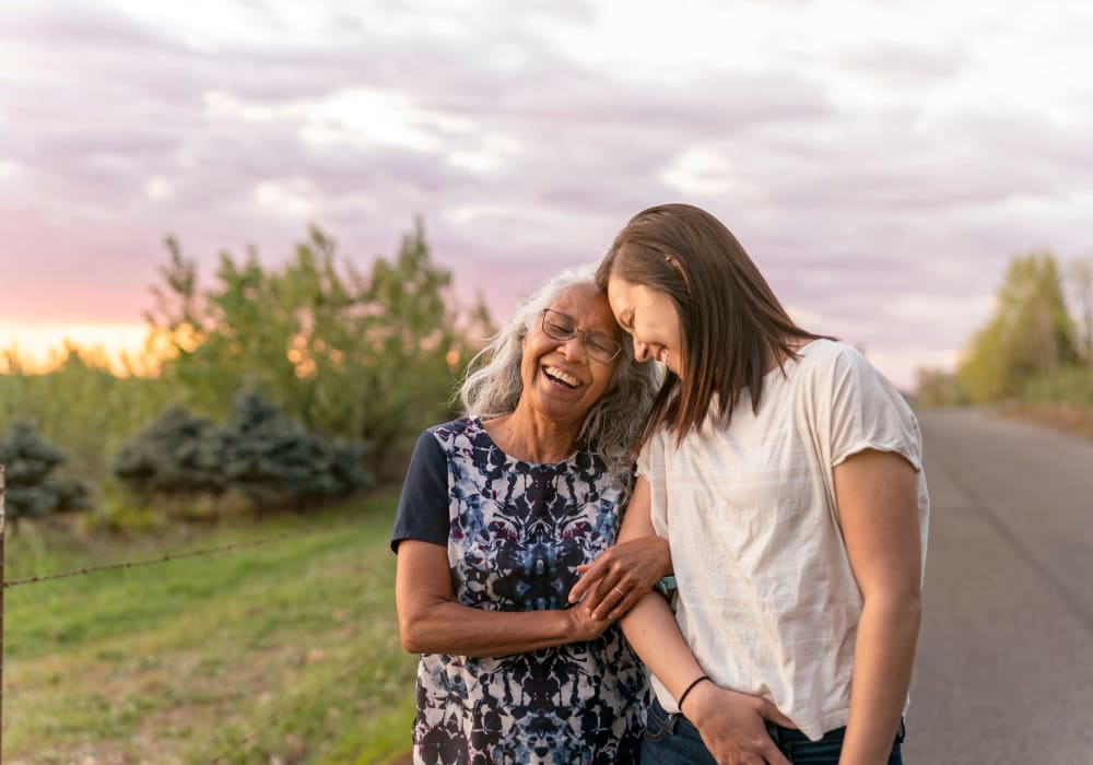 A younger person walking with a Stoney Brook resident. 