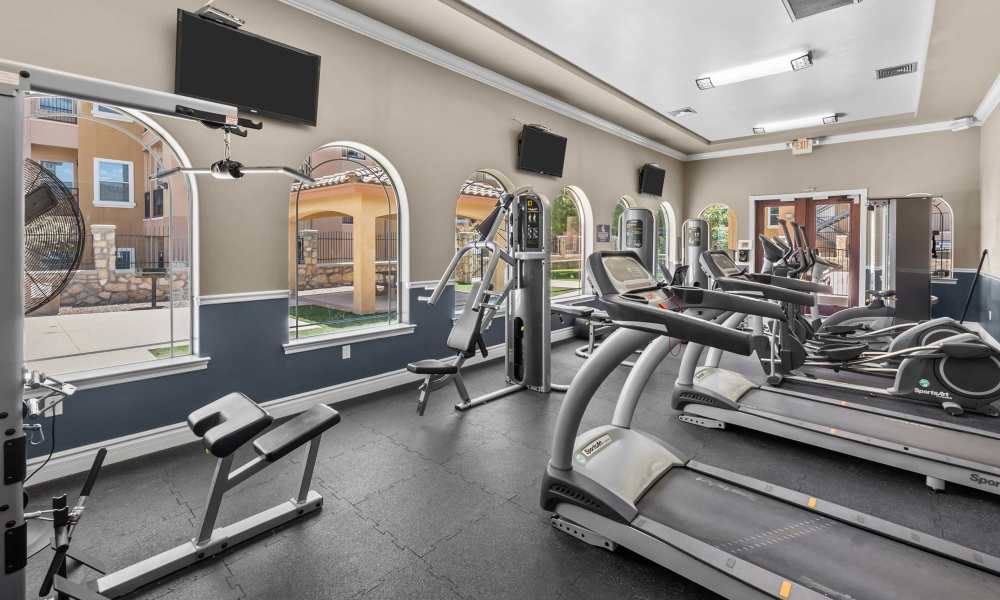 Well-equipped fitness center with multiple treadmills at Las Torres Apartments in El Paso, Texas