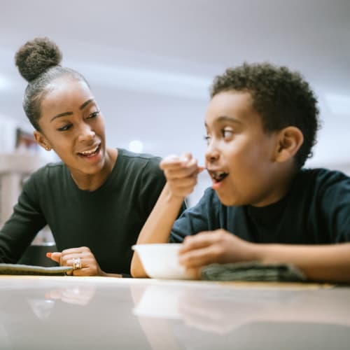 A mother and son eating cereal at Lofgren Terrace in Chula Vista, California