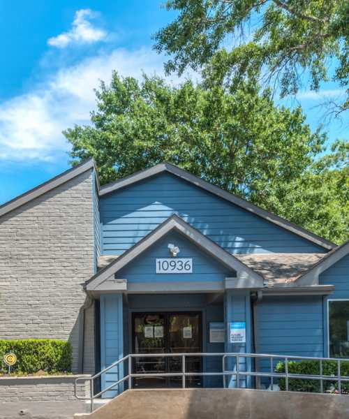 Property exterior with parking in the front at Warwick at Westchase in Houston, Texas