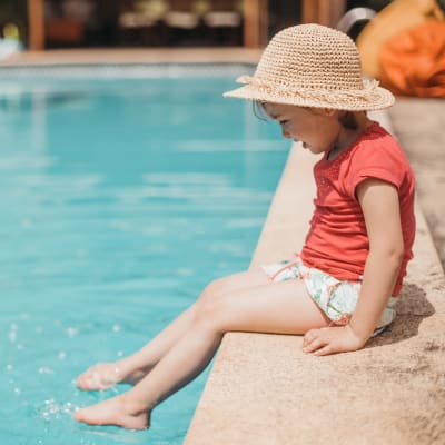 Child with their feet in the pool at Mountain View in Fallon, Nevada