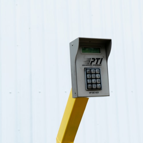 Secure entry keypad in front of a white wall at Red Dot Storage in Baker, Louisiana