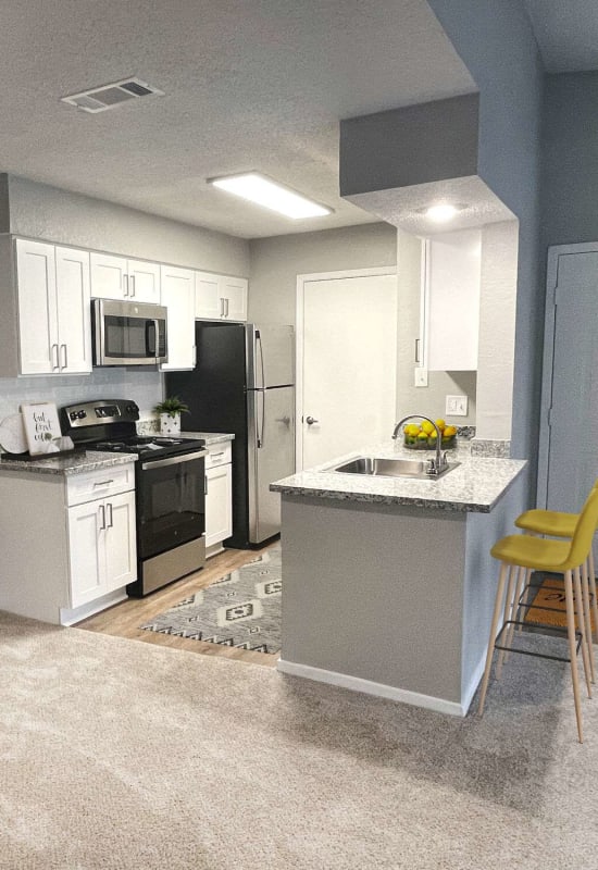 Kitchen with breakfast bar at Atlas at Lakeview in Baton Rouge, Louisiana