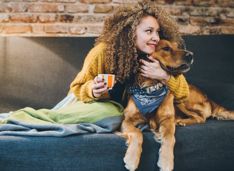 Resident with her golden retriever loving their new home at Ranch ThreeOFive in Arlington, Texas