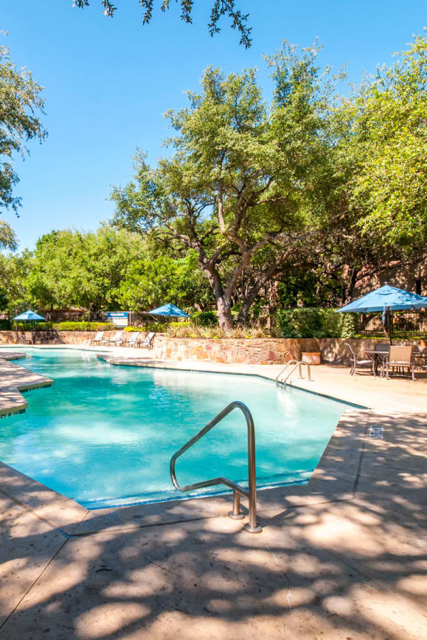 Pool area partially shaded by mature trees at Sonterra Heights in San Antonio, Texas