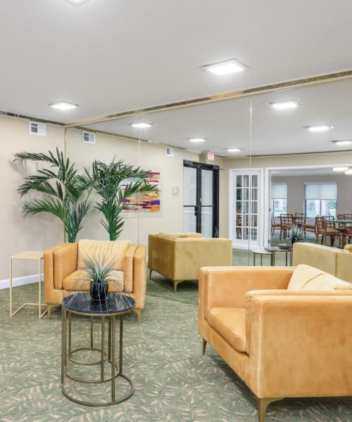 Comfy seating in the resident clubhouse at Farmington Oaks Apartments in Farmington, Michigan