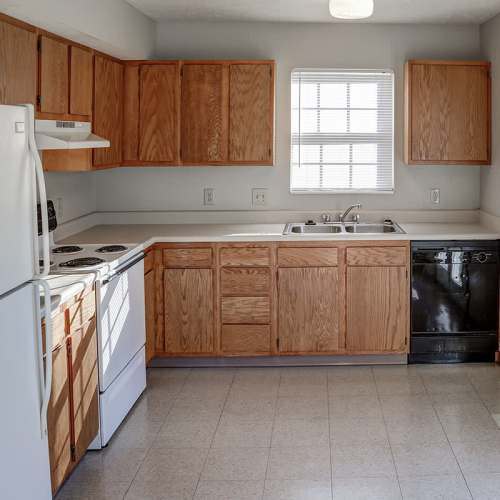 Kitchen with wooden cabinets and a window at Ivy Glen in Washington Court House, Ohio