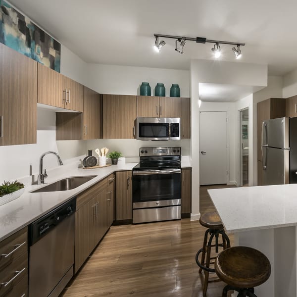 Kitchen with a small breakfast bar and stainless-steel fridge at The Maxx 159 in Goodyear, Arizona