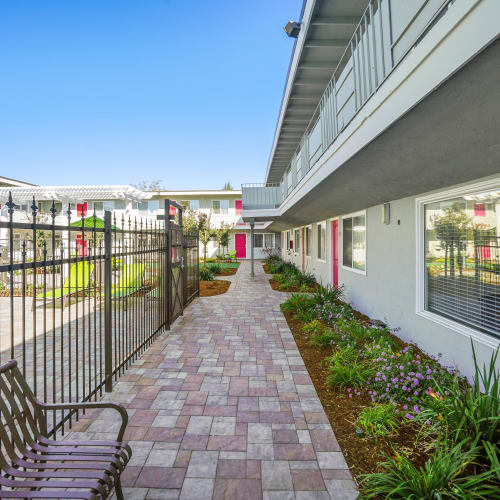 Exterior walkway with entrances to apartments from the courtyard at Bon Aire Apartments in Castro Valley, California