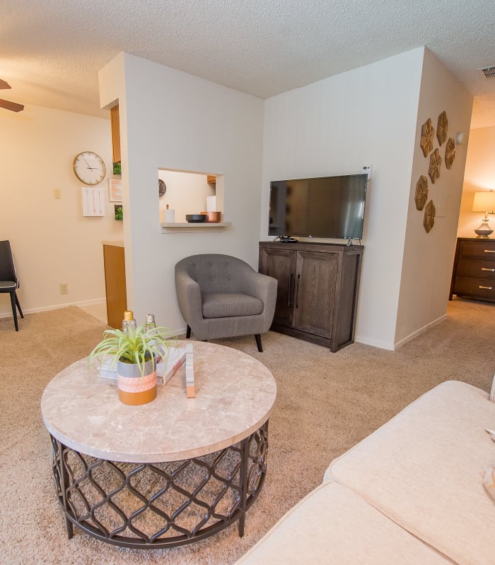 Carpeted living room at Sunchase Apartments in Tulsa, Oklahoma