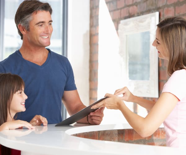 Friendly and helpful staff member assisting customers at 21st Century Storage