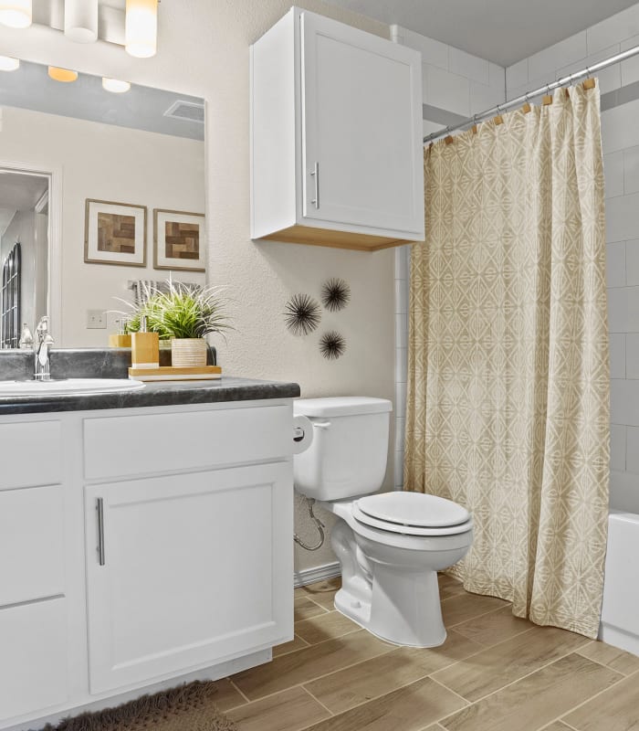 Bathroom with tile flooring at Cottages at Tallgrass Point Apartments in Owasso, Oklahoma