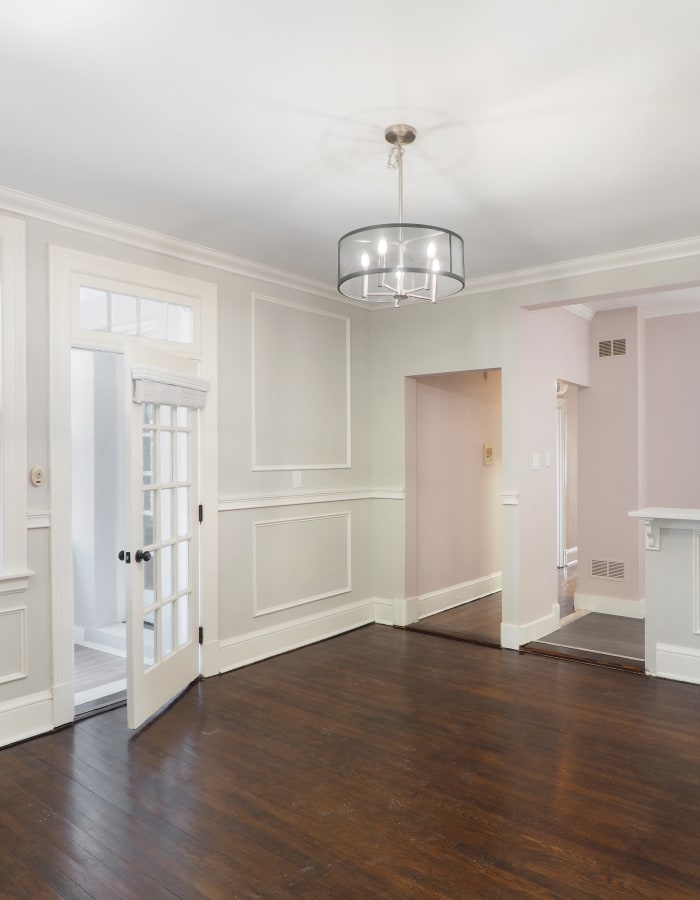 Dark hardwood floors outside of kitchen by entry to an apartment at Packard West Hartford in West Hartford, Connecticut