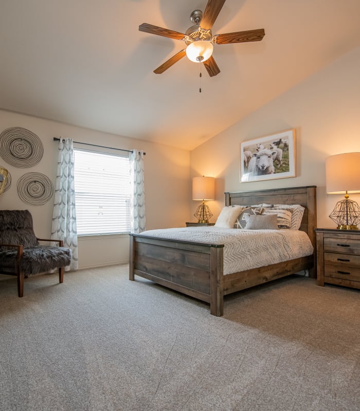 Chic bedroom with ceiling fan at Cottages at Crestview in Wichita, Kansas