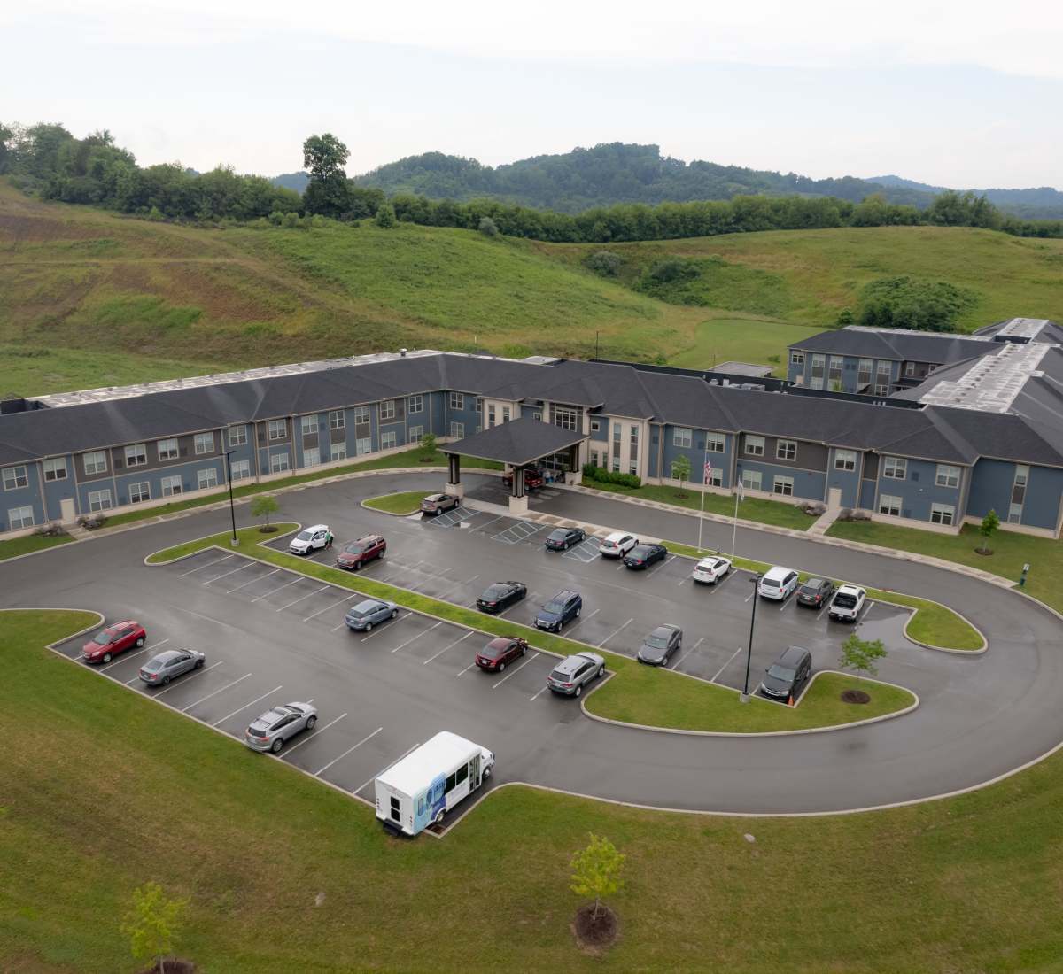Aerial view of community surrounded with greenery at Harmony at White Oaks in Bridgeport, West Virginia