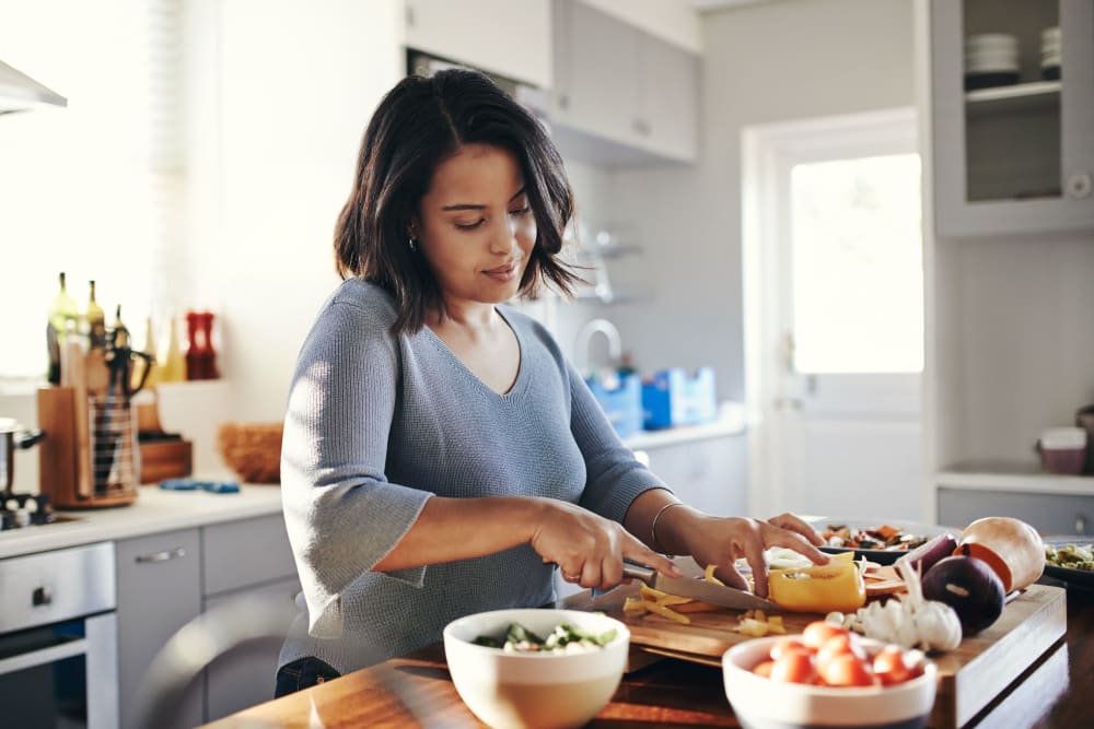 Woman cooking in spacious kitchen at The 450 in Lombard, Illinois
