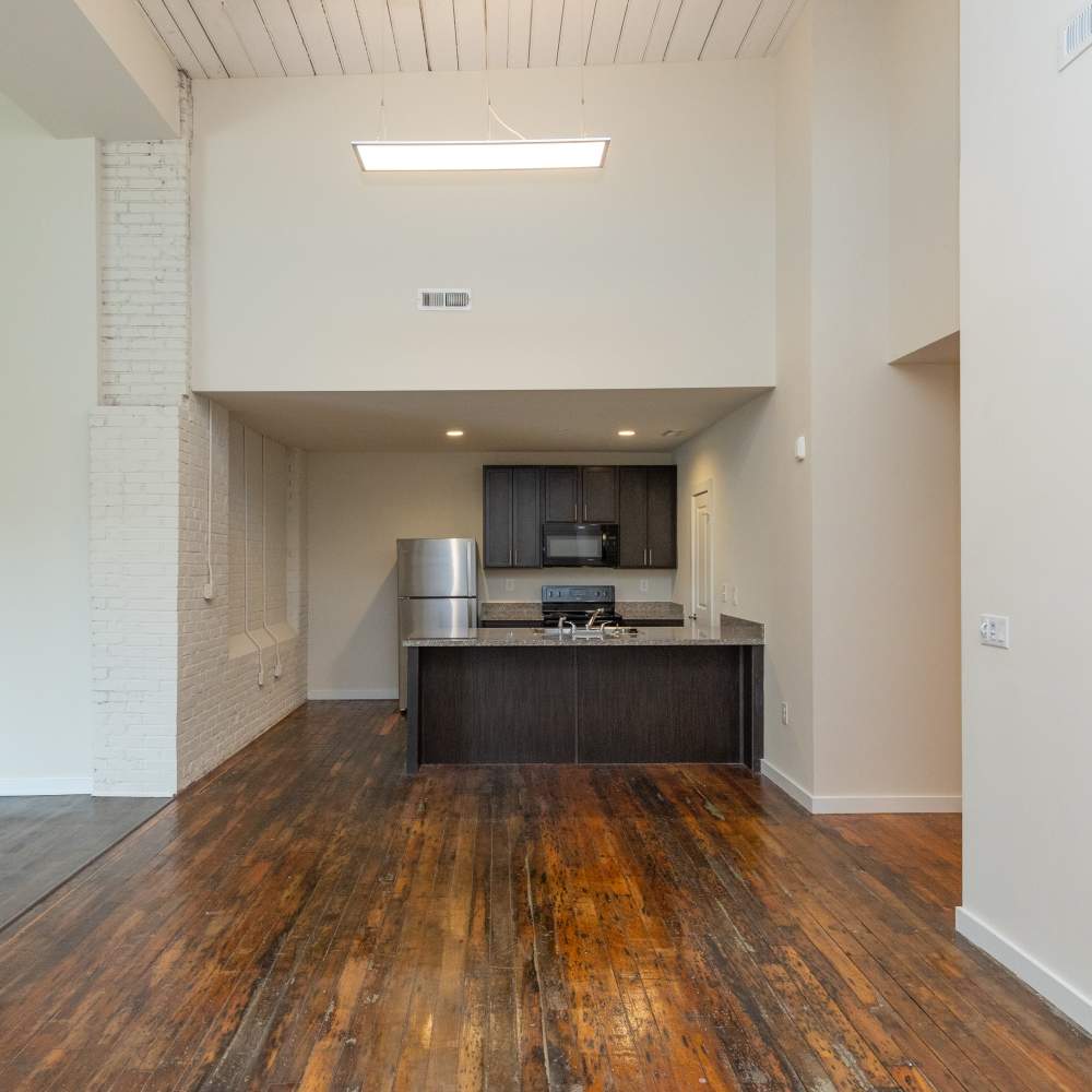 Bright living area with well-equipped open kitchen at Lofts at Inman Mills in Inman, South Carolina