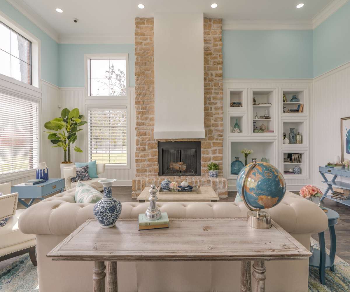 A spacious community lounge area with fireplace at Edgewater at Klein in Spring, Texas